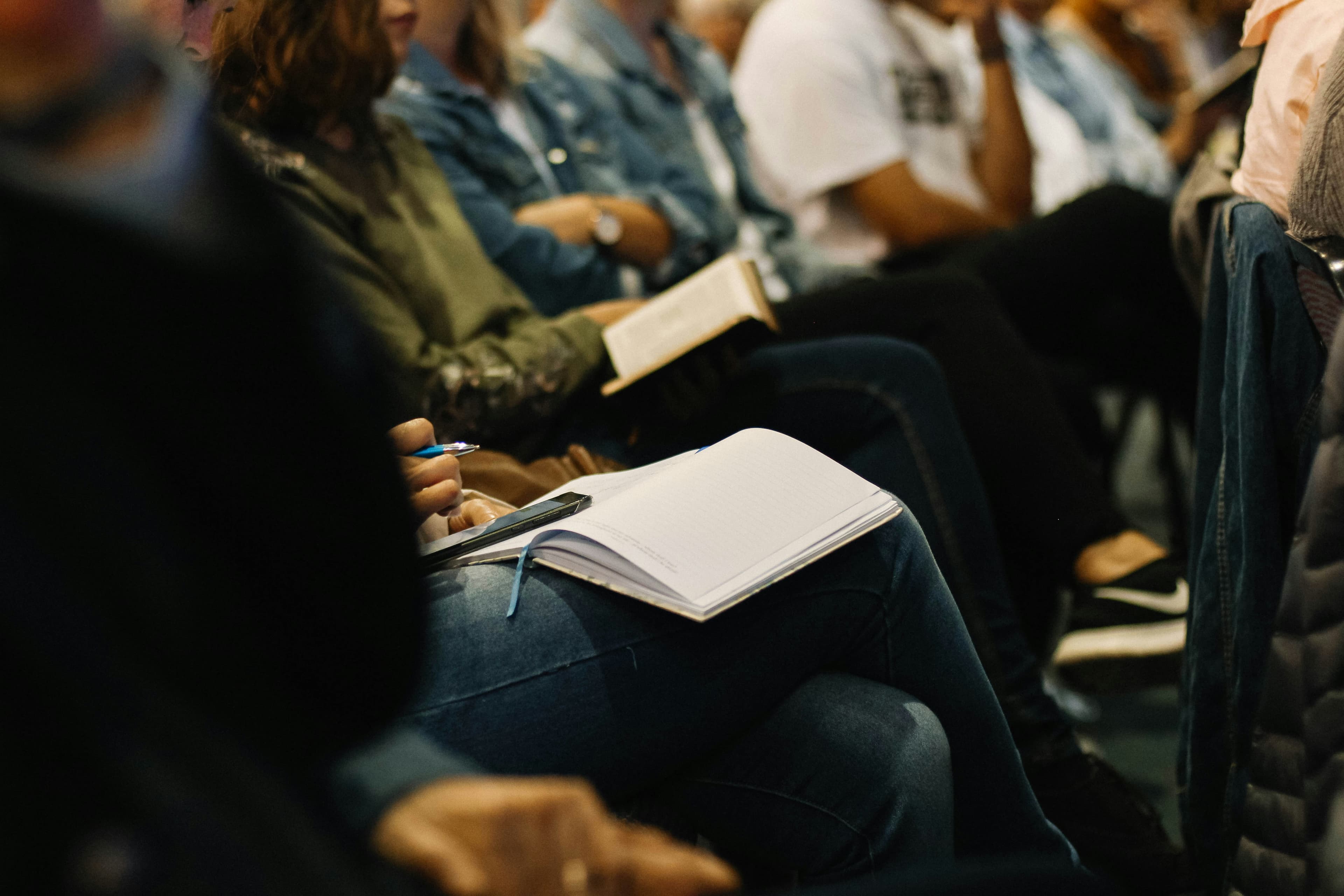 People studying together with open Bibles and notebooks